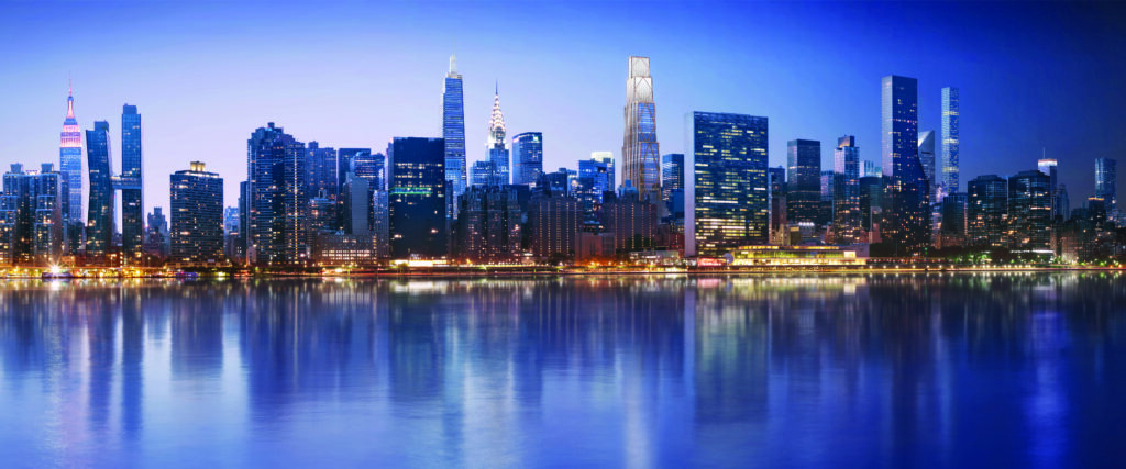 Panoramic view of a modern city skyline with tall skyscrapers reflected in calm water at dusk.