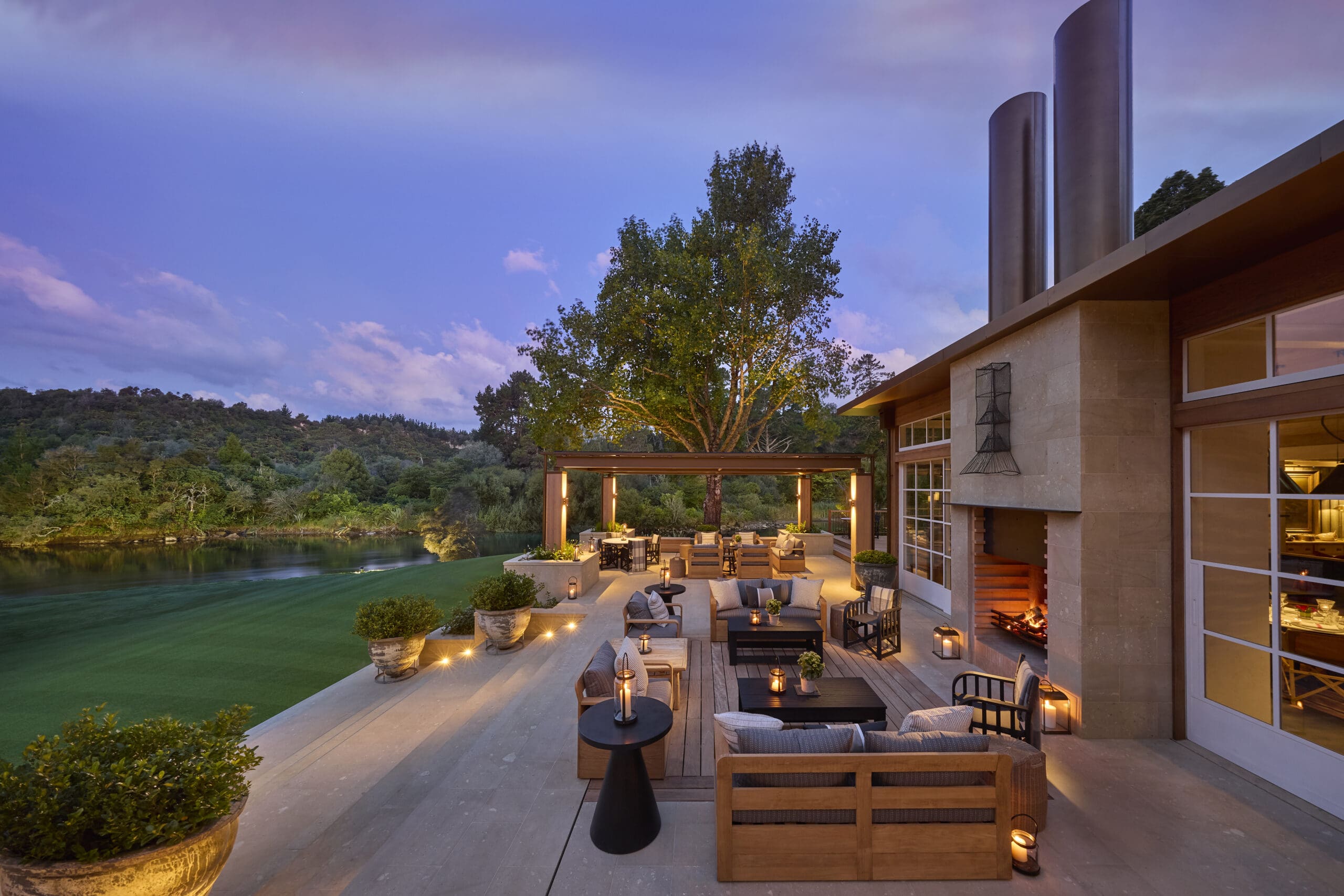 Twilight outdoor terrace with fire feature and countryside views