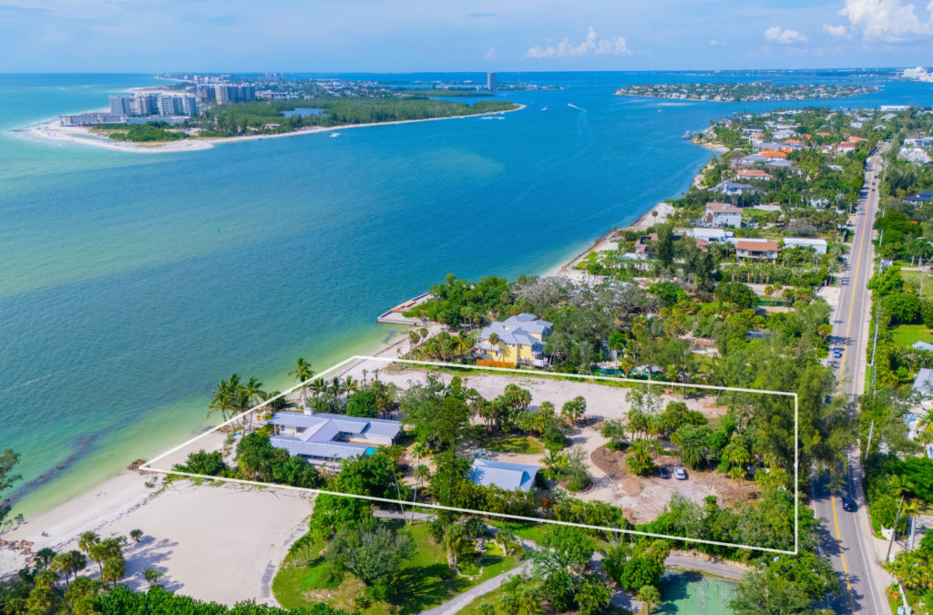 Aerial view of The Higel Estate on Siesta Key, featuring luxury waterfront residences, tropical landscaping, and Sarasota's Gulf Coast.